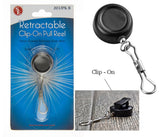 Black retractable clip-on pull reel shown both in its retail blister packaging and unpackaged. The packaging features a blue and white design with the text 'Retractable Clip-On Pull Reel' and a small red 'SE' logo.