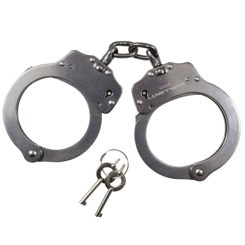 Metallic handcuffs with a key on a white background
