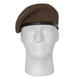 Brown beret on a mannequin head against a white background