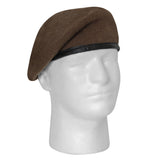 Brown beret on a mannequin head against a white background