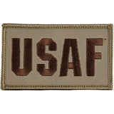 An embroidered rectangular USAF patch with brown lettering on a tan background, shown against a plain white background.