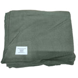 Folded green blanket with a label on a white background