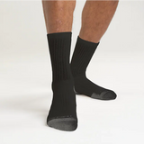 Black socks worn by a person on a white background