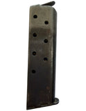 A used, dark metal magazine or grip component with circular holes, shown vertically on a plain white background.