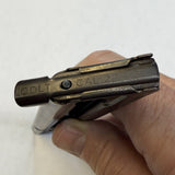 A close-up of a hand holding a Colt .44 caliber pistol magazine, showing the 'COLT .