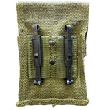 Green fabric pouch with metal clasps on a white background