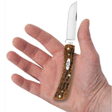 Small knife with a brown handle held in a hand on a white background