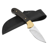 Knife with gold blade and black sheath on a white background