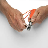 Person using a tool to cut an orange rope on a white background