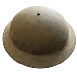 A vintage military-style steel helmet with a wide brim, shown from a top-down perspective on a concrete floor.