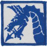 Blue embroidered dragon patch on a white background