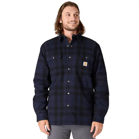 Man wearing a navy plaid shirt with a visible brand logo on a white background