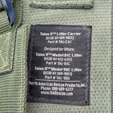 Close-up of a black fabric product label sewn onto the inside of an olive green woven carrier or bag. The label reads Talon II Litter Carrier and includes North American Rescue Products, Inc.