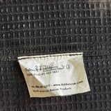 A close-up of a sewn-on fabric label on a dark textured woven surface. The label reads 'Talon 106' with 'Veterans Liberty' and 'North American Rescue Products' visible.