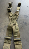 A tan tactical harness with multiple adjustable straps, metal buckles, and attachment points, shown against a plain white background.