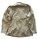 A long-sleeve button-up shirt with a vertical textured stripe pattern in olive green and beige, laid flat on a gray concrete surface.