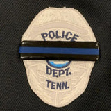 Police department badge with 'TENN.' on a black background