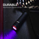 Black flashlight emitting purple light on a dark surface with 'NEDBO' branding.