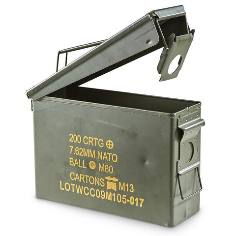 A green metal ammo can with a rubber seal in the lid, marked with military specifications for 30 Cal ammunition.